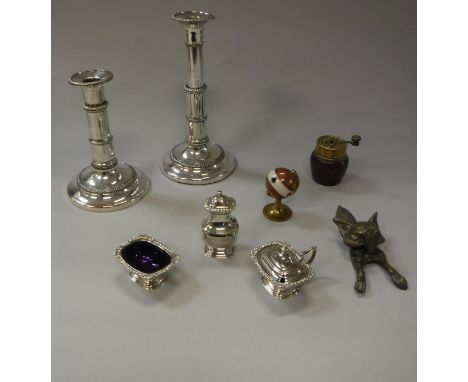 A collection of metal wares to include a pair of plated telescopic lamp candlesticks, a plated three piece cruet, a brass doo
