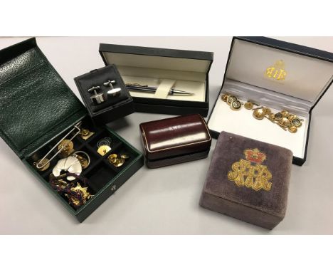 A box containing assorted cufflinks, studs, pen, knives, etc