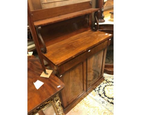 A late Regency mahogany chiffonier, the raised back with shelf on S scroll supports over a single drawer and two cupboard doo