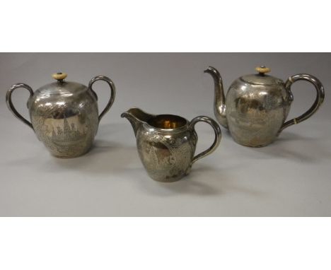 A circa 1900 Russian silver three piece teaset of ovoid form with engraved decoration of Moscow scene bearing "84 zlotnik" ma