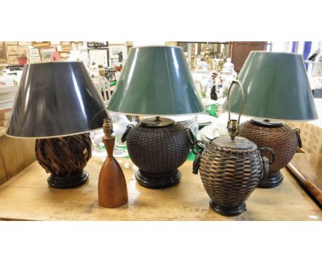 Four various modern canework based table lamps and a turned wooden table lamp CONDITION REPORTS Condition of lamp bases basic