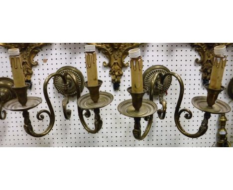 A pair of brass twin light wall sconces with serpent head decoration together with two pairs of Dutch style single wall light