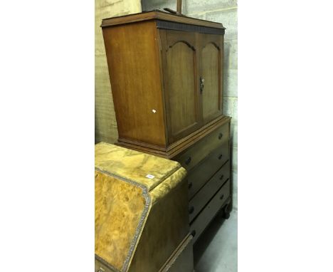 An early 20th Century mahogany bedroom cabinet with two cupboard doors enclosing shelf and two drawers over four long drawers