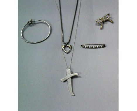 A collection of silver Tiffany jewellery comprising bangle, Paloma Picasso cross pendant, love heart necklace, bow brooch and