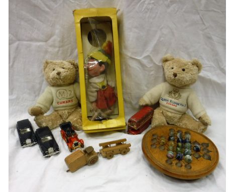 Two boxes of various games and toys to include model vehicles, vintage solitaire set, marbles, Pelham Puppets Pinocchio, soft