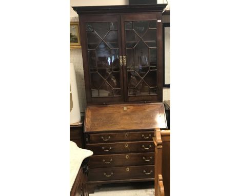 A George III mahogany bureau bookcase, the upper section with astral glazed cabinet doors enclosing adjustable shelving over 