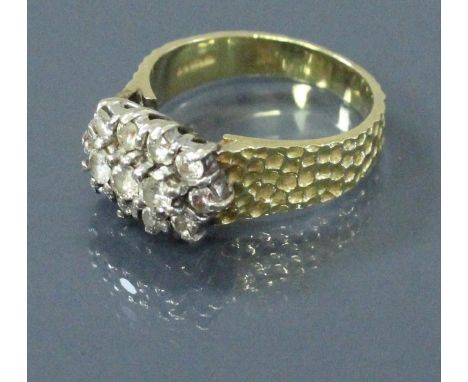 An 18 carat gold bark effect ring with diamond cluster of thirteen diamonds, total diamond weight approx 0.8 carat, ring size