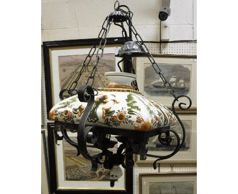 A modern black painted wrought iron and glazed pottery ceiling light