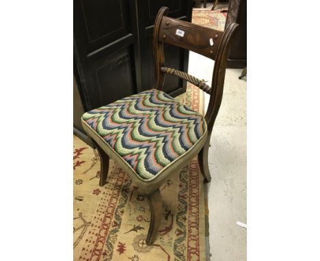A set of six early 19th Century mahogany bar back dining chairs with rope twist and bobbin turned back rail over upholstered 