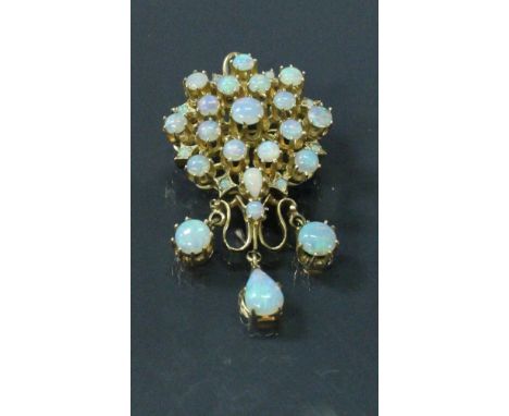 A 14 carat gold and opal set pendant / brooch, the central cluster set with 26 opals and three further opals suspended beneat