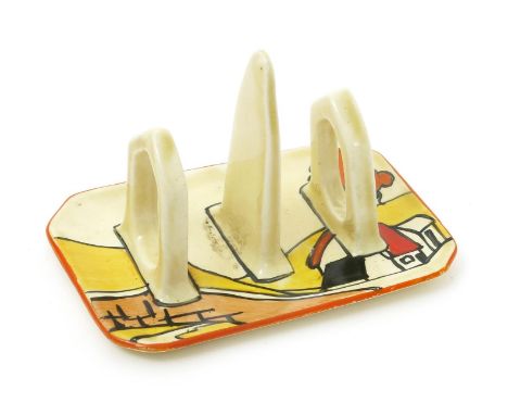 'House and Bridge' a Clarice Cliff Bizarre toast-rack, painted in colours, printed factory marks,12.5cm. wide. Provenance Pet