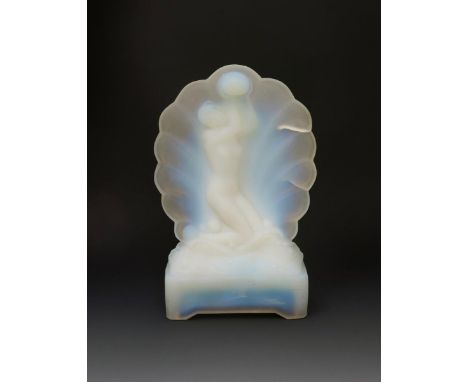 An opalescent glass table lamp, cast in relief with a maiden holding up a globe before a scallop shell, on rectangular base u