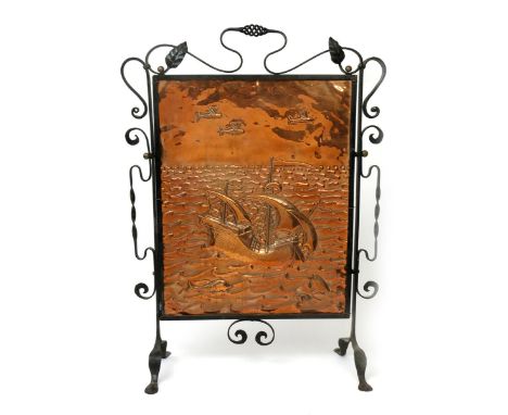 An Arts and Crafts copper and patinated iron firescreen,  the rectangular copper screen stamped in relief with a galleon at f