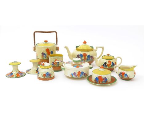 'Crocus' a Clarice Cliff Bizarre Cylindrical biscuit barrel and cover, painted in colours above brown and green bands, with w