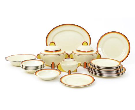 A Clarice Cliff Bizarre dessert and dinner service, painted with yellow, orange, red and black bands, comprising serving bowl