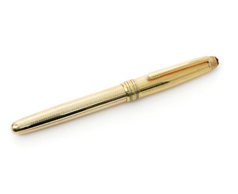 A Mont Blanc Meisterstuck rolled gold fountain pen, with engine turned decoration, 13.5cm. long
