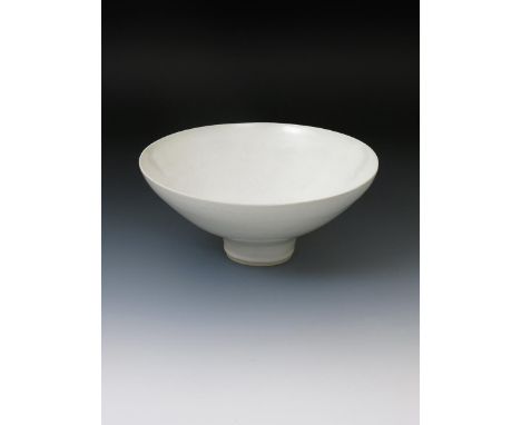 ‡  Dame Lucie Rie DBE (1902-1995)  a large flaring porcelain bowl, covered to the foot with a gloss white glaze, impressed ma