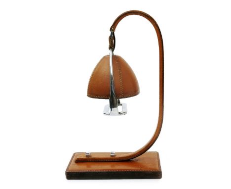 A leather stirrup table lamp in the style of Hermes,  with chrome fittings unsigned, 37cm. high