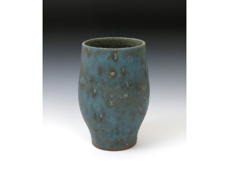 Dame Lucie Rie DBE (1902-1995) a stoneware vase, swollen form, covered in a running and pitted blue glaze, impressed seal mar