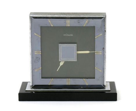 An Art Deco Jaeger LeCoultre mantle clock,  rectangular form with movement to both sides, on black slate base, with presentat