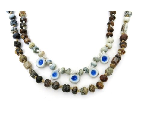 A string of ceramic beads by Joan Sydenham, variously decorated with impressed designs  and glazes, and another string of bea
