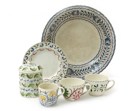 A Wedgwood Pottery bowl by Grace Barnsley,  low, flaring form painted with bands of simple leaf motif in blue, highlighted wi