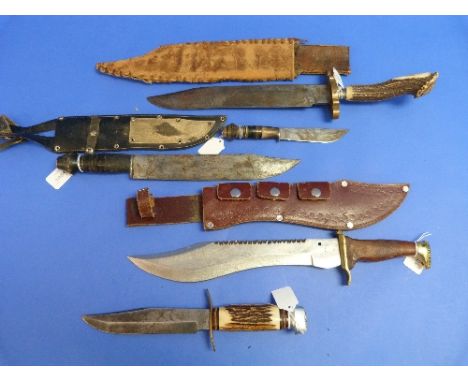 A large vintage Bowie knife, with 12in (30.5cm) blade, brass mounted wood handle and leather sheath, together with four other