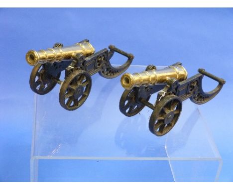A pair of vintage ornamental Canon, each with a brass canon on cast iron carriage, 18in (45.5cm) long (2)