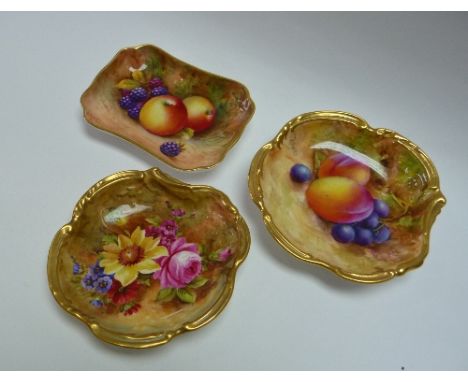 A pair of Royal Worcester porcelain pin Dishes, of scrolled circular form with gilt borders, painted in coloured enamels with
