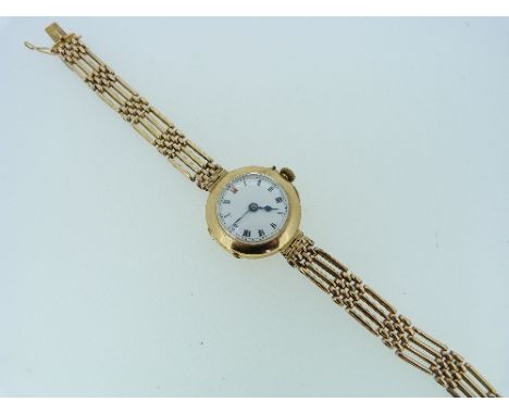 A lady's 15ct gold Wristwatch, with circular white dial and black Roman numerals, on a 15ct gold gate-link bracelet.