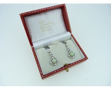 A pair of modern opal and diamond drop Earrings, in Edwardian style, with the pillar and mount set small diamonds around cent