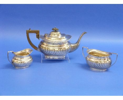 An Edwardian silver three piece Tea Set, by John Rose, hallmarked Birmingham, 1904, of ovoid form, with demi-fluted decoratio
