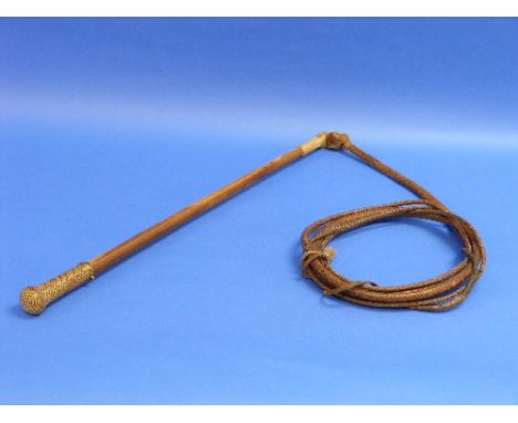 An Early 20thC Whip/Sword Stick, with plaited leather pommel and a gilt metal collar with button releasing a short sword with