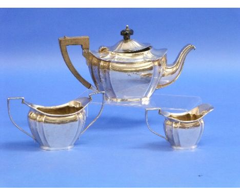 An Edwardian silver three piece Tea Set, by William Devenport, hallmarked Birmingham, 1908, of shaped ovoid form, the teapot 