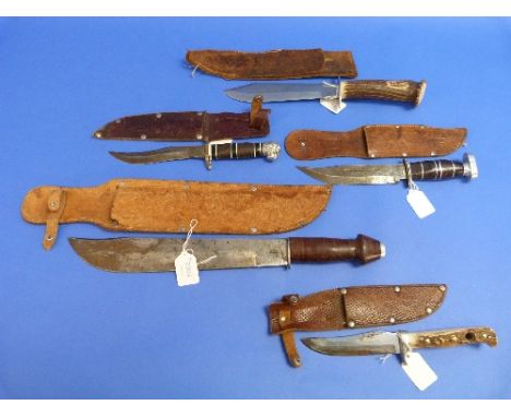 A large vintage Mexican Bowie knife, by A. P. Cosmo, with 11¾in (30cm) blade, wood handle and leather sheath, together with f