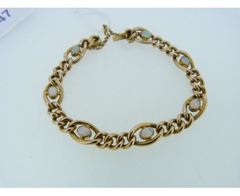 An attractive 9ct yellow gold link Bracelet, formed of seven larger open oval links, each set in the centre with a good colou