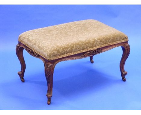 A Victorian walnut Rococo-style Stool, the rectangular stuff-over seat above a moulded rail and cabriole legs, with scroll to