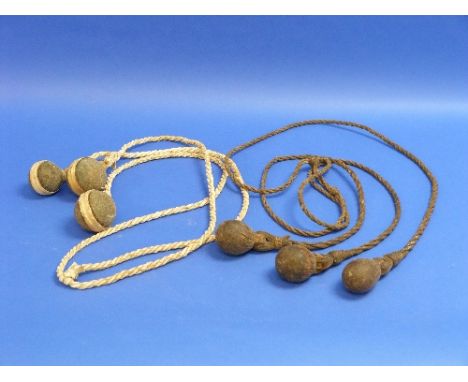 A Set of Vintage South American Plains Bolas, with leather plaited cords terminating in hide bound stone balls, together with