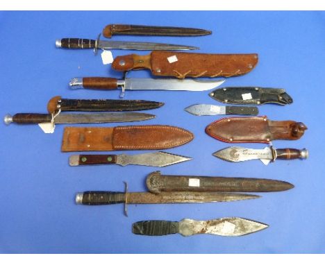 A vintage German throwing knife, Rotpunkt Wurfmesser, with leather sheath, together with three other various throwing knives,