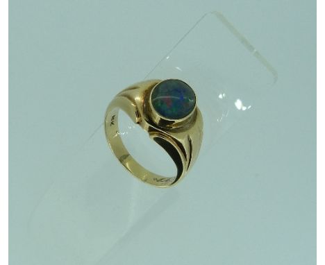 A oval opal doublet Ring, set in a 10k yellow gold mount with detailing on shoulders, Size U½.