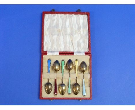 A cased set of six Elizabeth II silver gilt and enamel Coffee Spoons, hallmarked Birmingham, 1972, the gilded bowls with vari