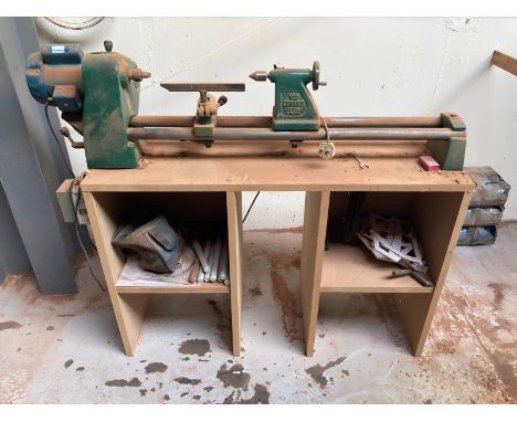 A Coronet 220/240v wood turning lathe on mdf stand, with a small quantity of lathe tools, width 150 cm CONDITION REPORT: Plea