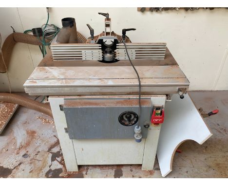 An Axminster four speed spindle moulder, model WS1000TA, 230v, together with a wall shelf containing accessories (See image),