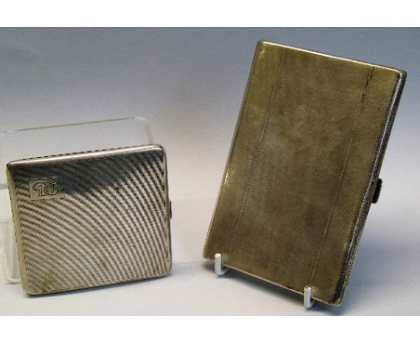 A cigarette case, of oblong form with engine turned ground, the interior with spring assisted cigarette holder and inscriptio