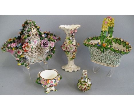 A continental basket shaped bowl, the pierced body and fixed handle with painted panels of birds and all over encrusted flowe