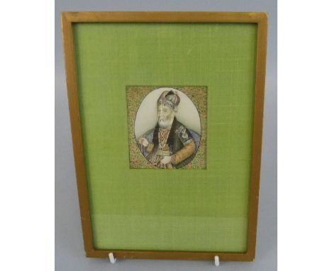 An Indian Moghul miniature on ivory, half length portrait of an elder seated holding a hookah pipe, 6.5cm square, in gilt fra