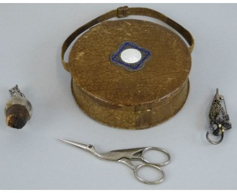 An early 20th Century French evening bag, of drum shaped form with simulated leather cover and carrying handle, the hinged to