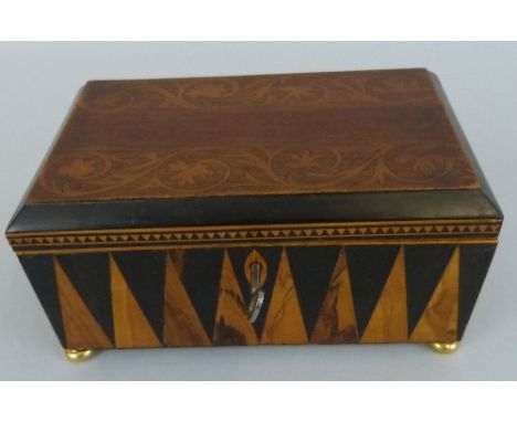 A 19th Century trinket box, of oblong form, the chamfered hinged top inlaid with bands of scrolling foliage on a base with sp