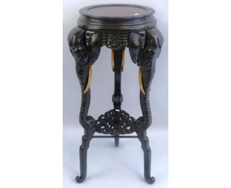 A Chinese ebonised jardiniere stand, the circular inset marble top with moulded rim, pierced key pattern panels to the frieze