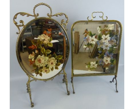 A brass framed fire screen, of oval form with scrolling and beaded mounts, the central bevelled mirrored panel painted with r